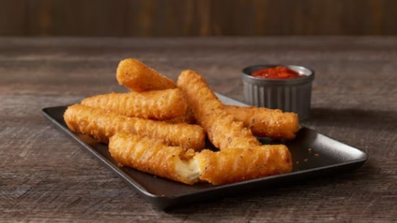 Mozzarella sticks on a black tray