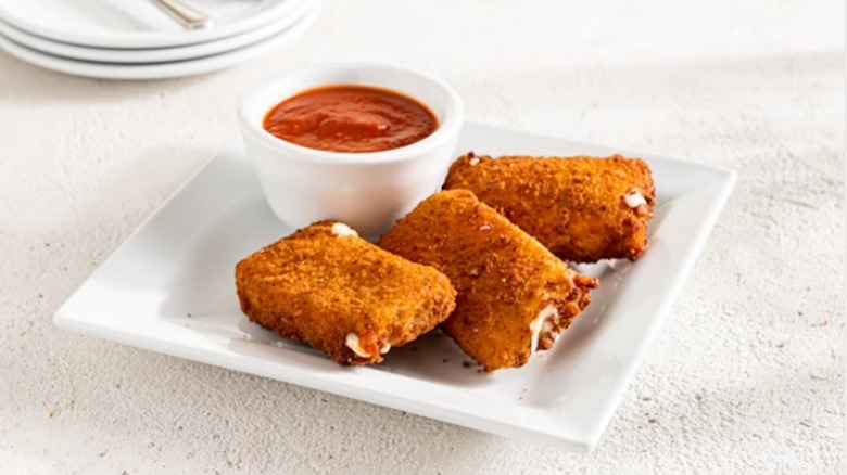 Wide mozzarella sticks on white plate