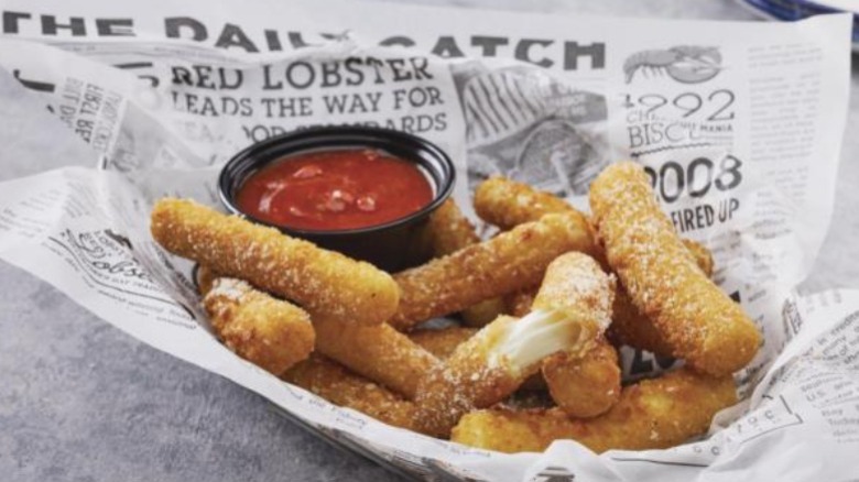 Mozzarella sticks on newspaper red sauce