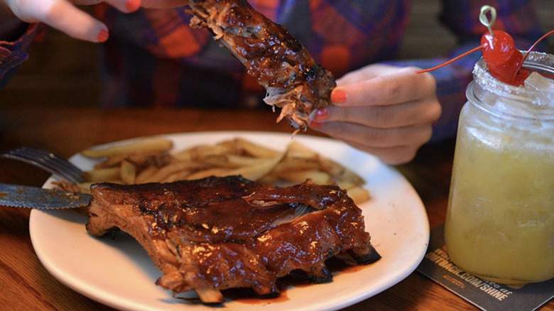 Woman eating Outback Steakhouse ribs