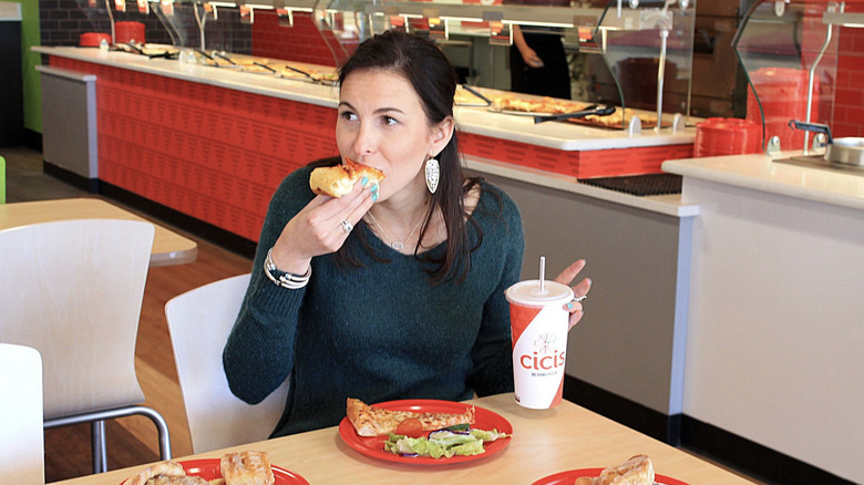 woman eating at Cicis Pizza