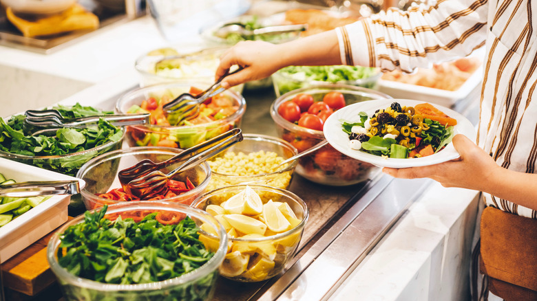 woman choosing food at buffet