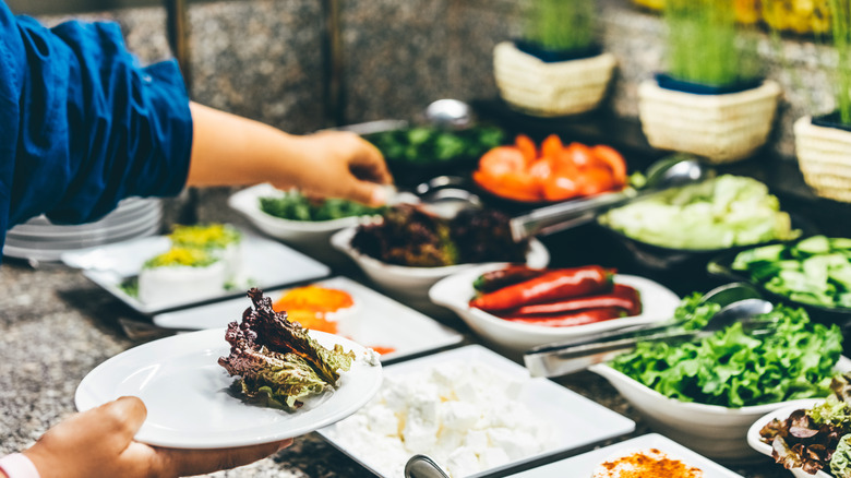 Man taking food from buffet