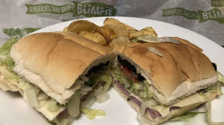 Blimpie sub split down the middle with a side of chips