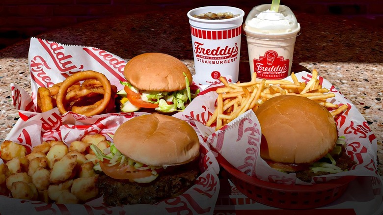 Three burgers with sides and two drinks from Freddy's