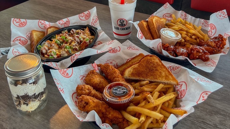 Table full of Slim Chickens combo meals