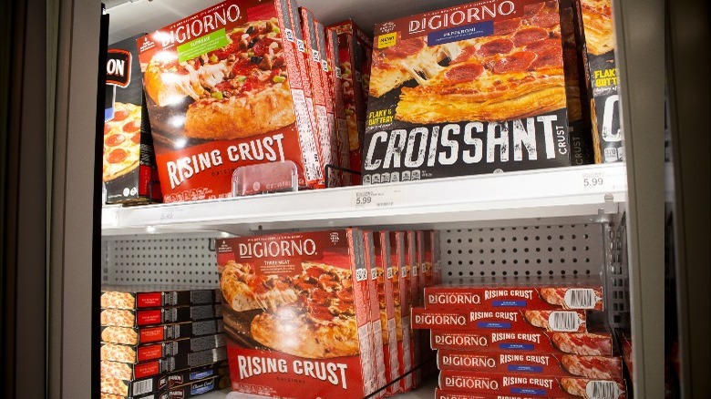 frozen pizzas in supermarket freezer