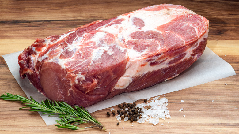 raw pork shoulder with rosemary