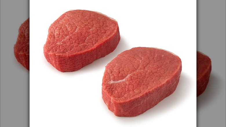 Two raw eye of round steaks