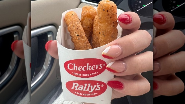 Hand holding mozzarella sticks