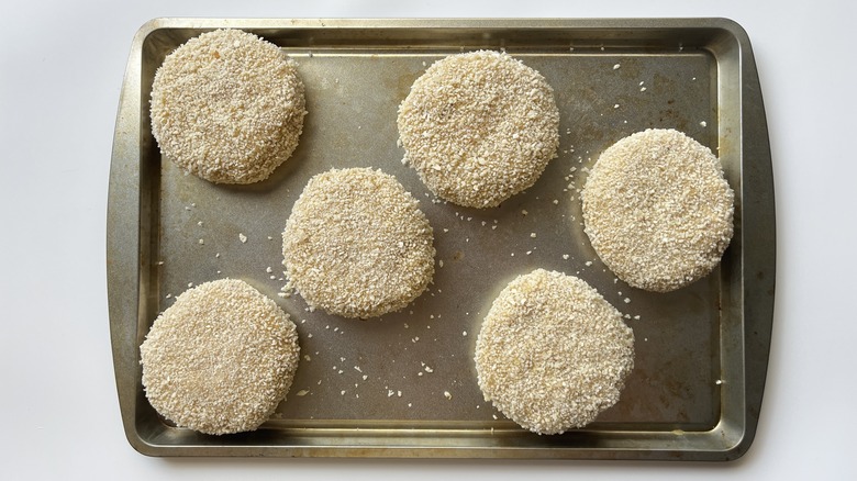 breaded chicken patties in pan