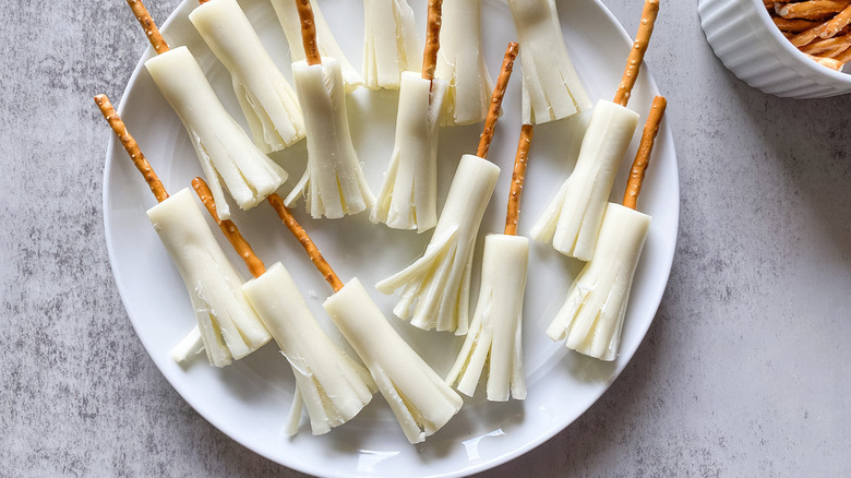 cheese and pretzel broomsticks plated