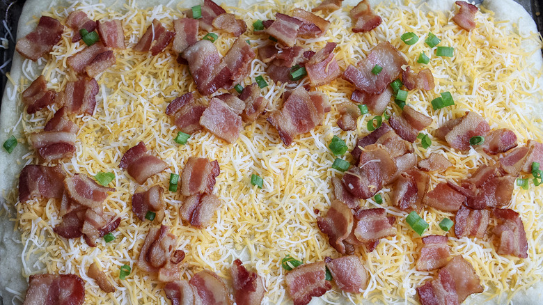 unbaked cheese and bacon pizza