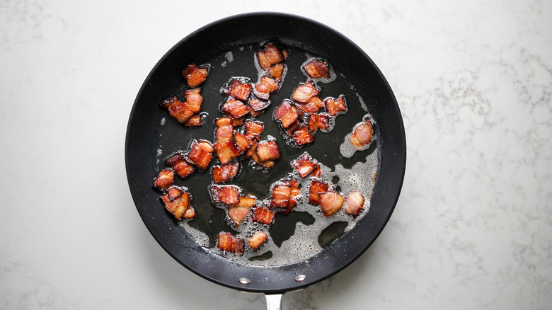 chopped bacon in frying pan