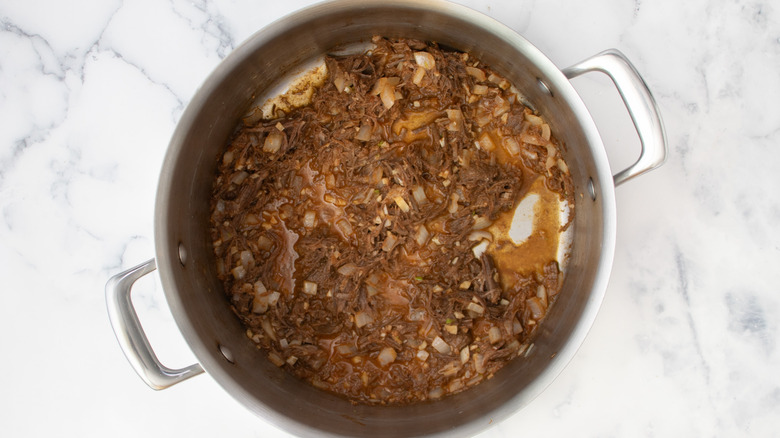 pulled beef simmering in pot