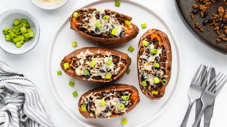 cheesy beef stuffed sweet potatoes on plate