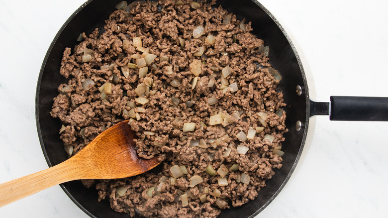 ground beef and onion frying in pan