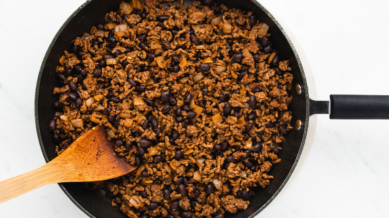 ground beef and black beans in pan