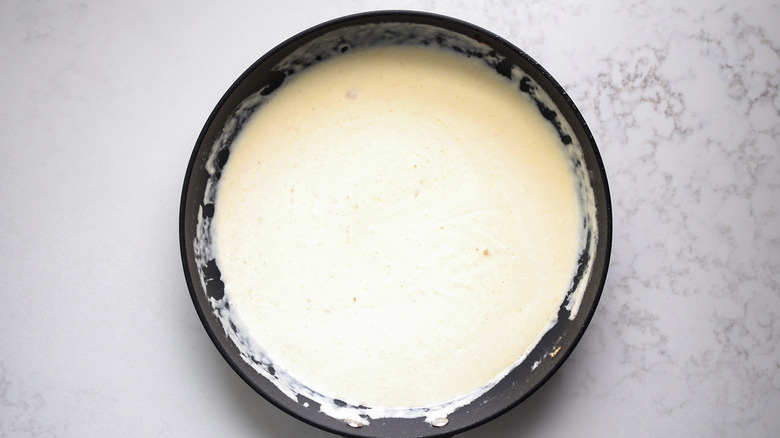 beige sauce in black pan