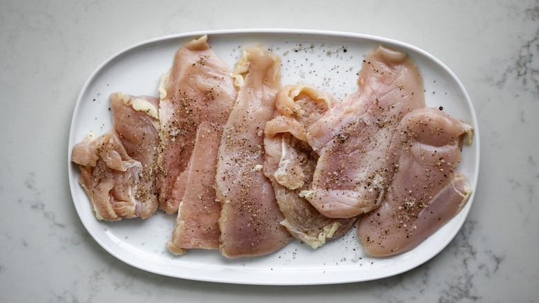 raw chicken on white plate