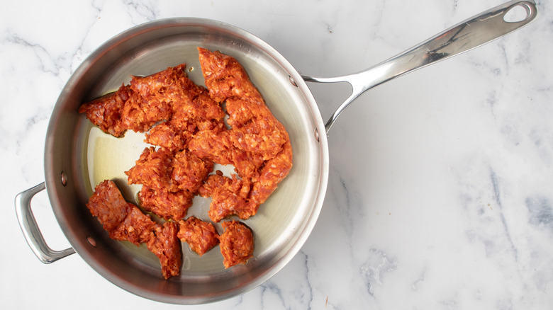 raw ground meat in a frying pan