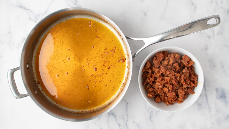 oil in a frying pan and cooked ground meat in a white bowl