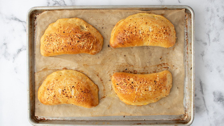 baked calzones on brown paper