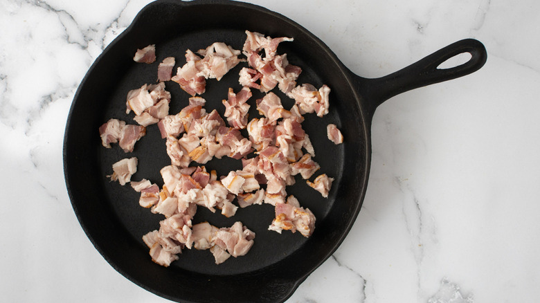 chopped raw bacon in pan