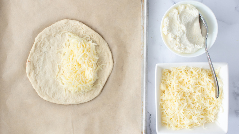 raw pizza dough with cheese