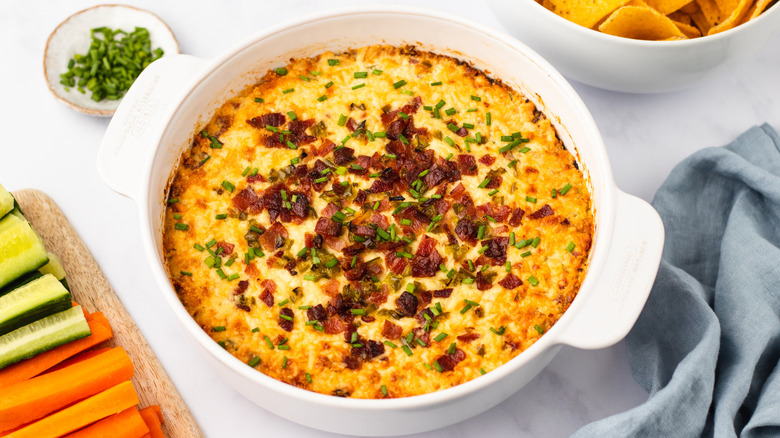 Cheesy bacon jalapeño dip in white dish