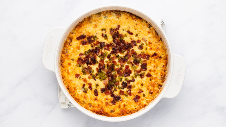 Cheesy bacon jalapeño dip in white dish