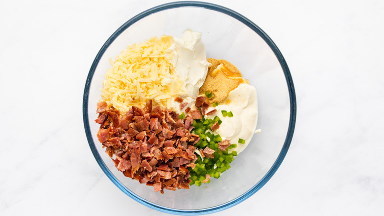 Cheesy bacon jalapeño dip ingredients in glass mixing bowl