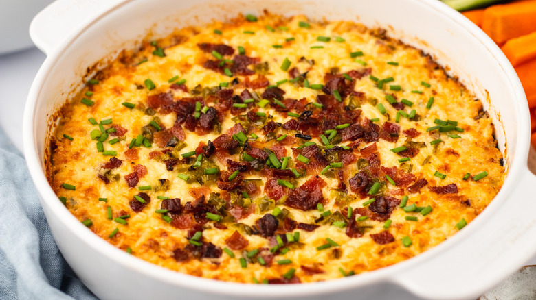 Cheesy bacon jalapeño dip in white dish