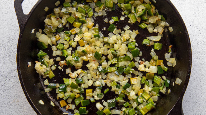 onions and peppers in pan