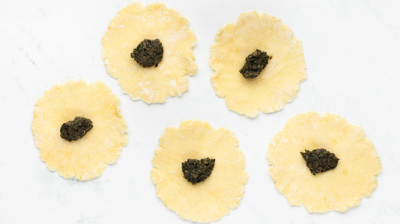 circles of gnocchi dough with mushroom filling