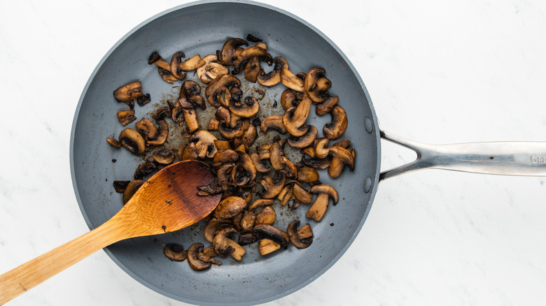 mushrooms sauteing in pan