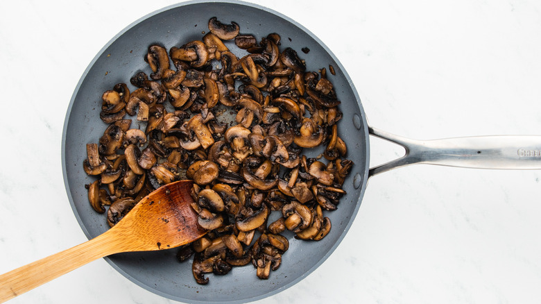 mushrooms and garlic sauteing in pan