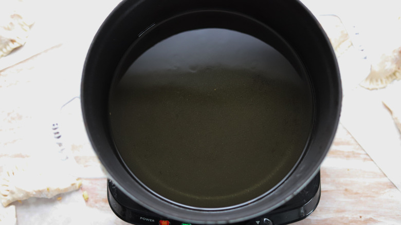 vegetable oil heated in a pot