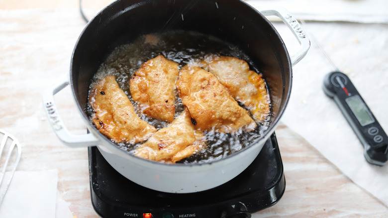 empanadas frying in oil