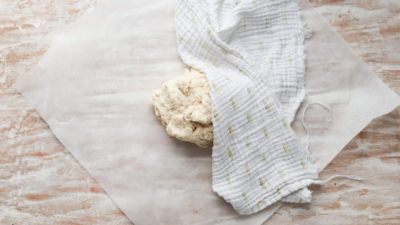 empanada dough resting under a towel