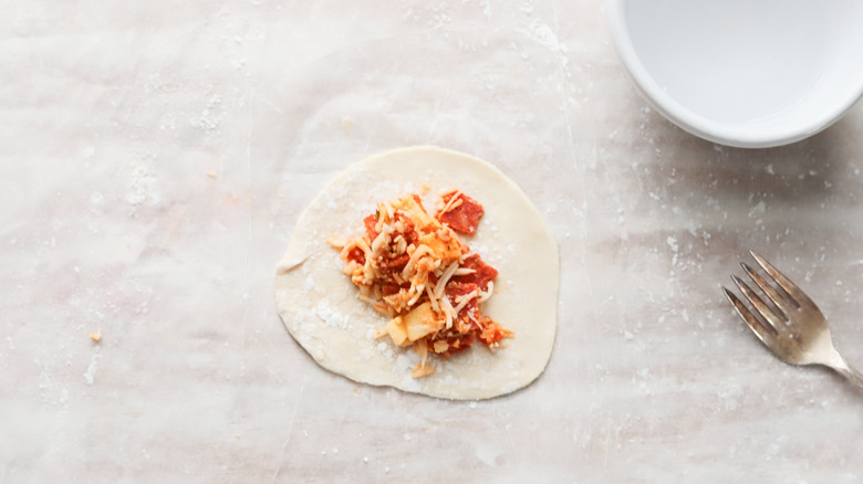 empanadas being filled