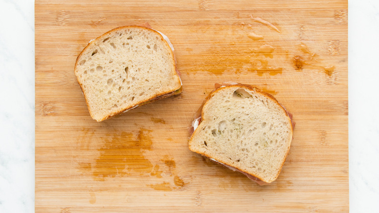 Two sandwiches on wooden board