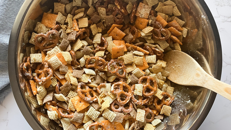 Stirring Chex mix in bowl