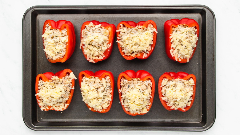 stuffed peppers on baking sheet