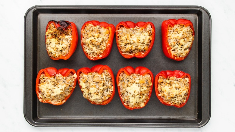 baked stuffed peppers on baking sheet