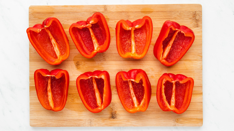 halved peppers on chopping board