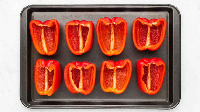 halved bell peppers on baking sheet