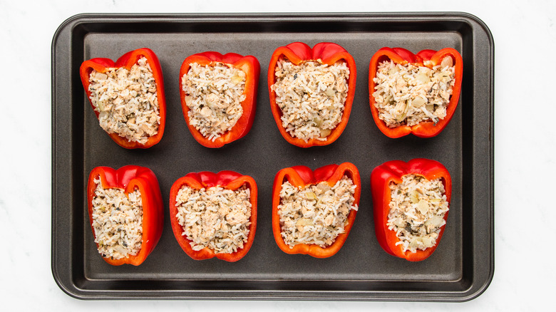 salmon stuffed peppers on baking sheet