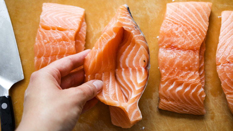 holding salmon fillet with slit