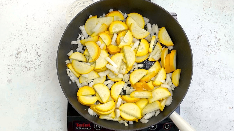 squash and onion  in pan